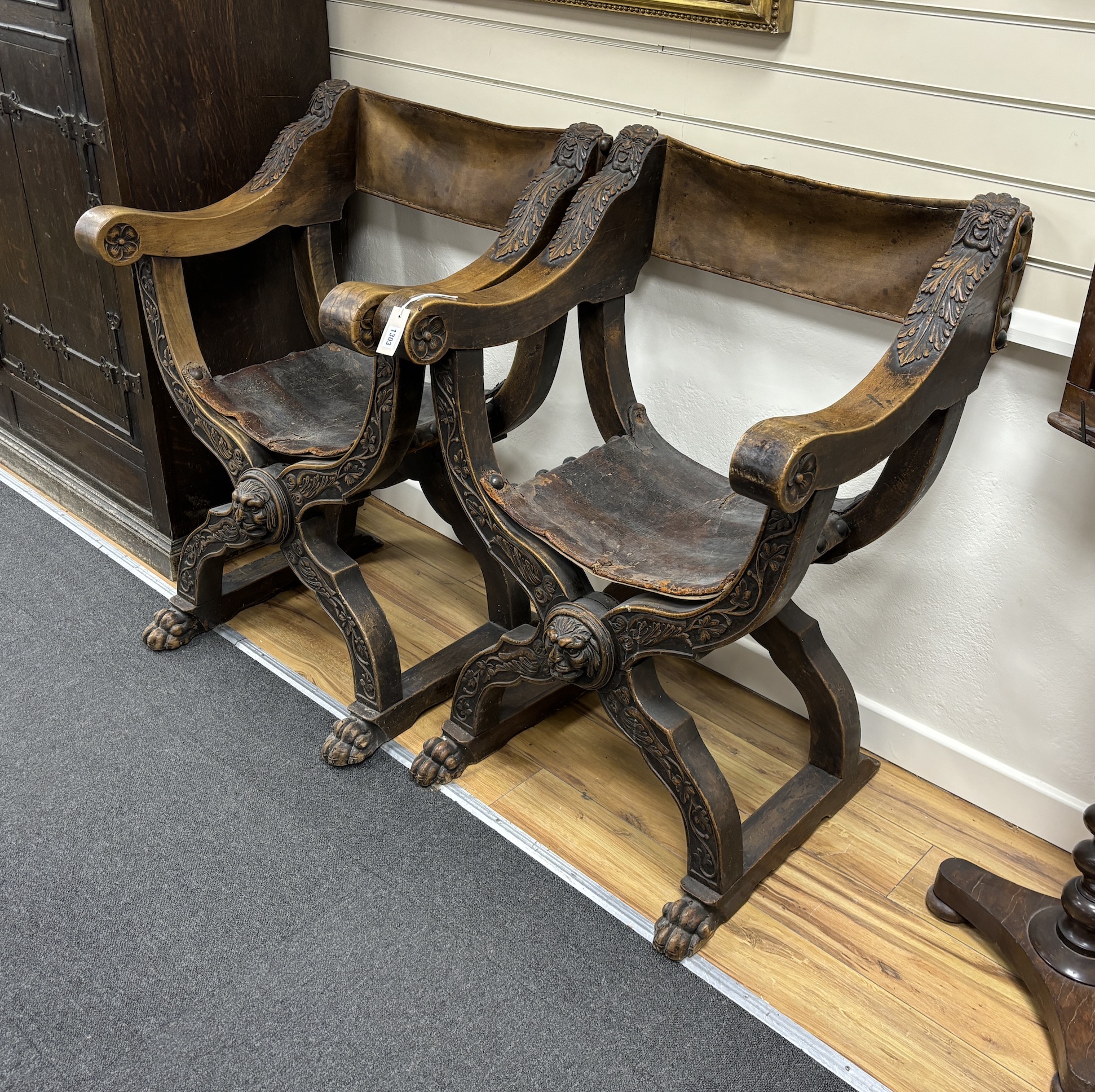 A pair of 19th century Italian Savonarola ‘’X’’ framed elbow chairs, with leather backs and seats, width 72cm, height 104cm, Please note this lot attracts an additional import tax of 5% on the hammer price